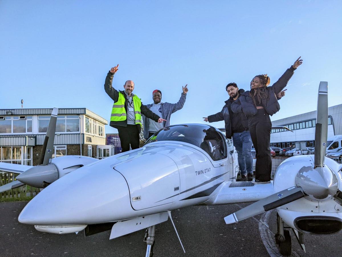 FTA Global MD Sean Jacob with University of Brighton students on pilot training aircraft.jpg.gallery